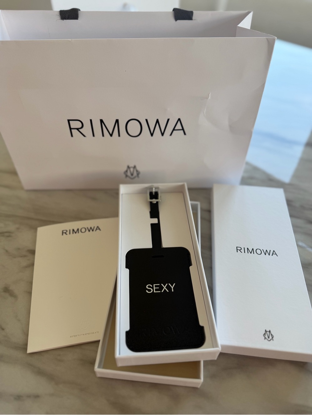 RIMOWA Black Luggage Tag with "SEXY" Text